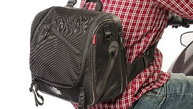 Picture of a rider wearing an Iron Rider Messenger Bag, made by Dowco. 