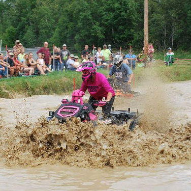 Anne Kotula of Grand Rapis Minnesota riding her ATV through a mud bog. 