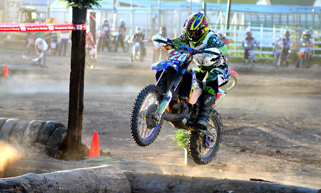 This year, Shane Cuthbertson has been competing in Alberta as well as in Idaho and Montana on his 2012 Husaberg TE 300. He placed third overall at an endurocross event held in Kalispell, Montana, at the end of June. <br /><strong>- Charla Cuthbertson photo</strong> A guy in blue and green riding gear jumping a blue dirt bike over a log on a track.