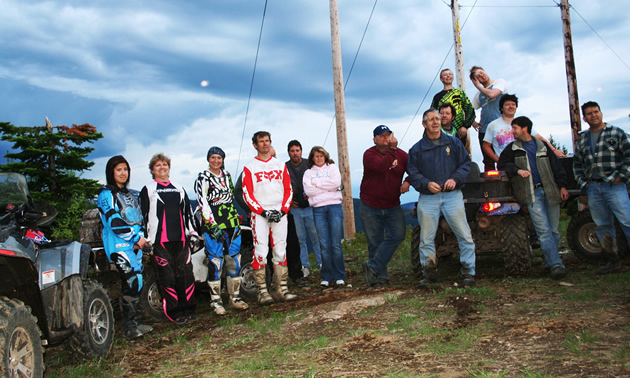 Mothers, daughters, fathers, sons, husbands and wives all enjoyed spending time together during the Summer Solstice Ride. — Brook Evans photo A group of ATVers and dirt bikers lined up together.