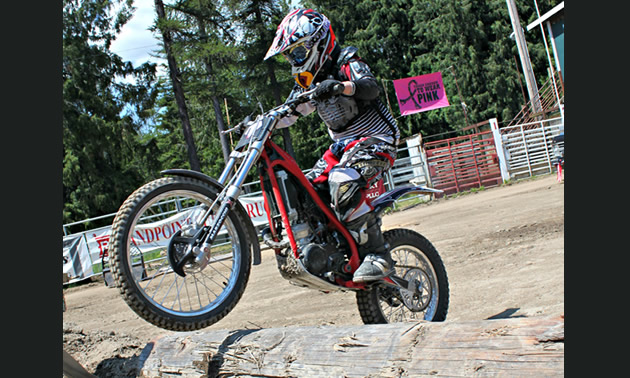 Off-road racer Chase Cuthbertson, who is nine years old, competes in the peewee expert class; this year, Chase got into trials riding competitions. <br /><strong>- Charla Cuthbertson photo</strong> Photo of a kid on a trials bike riding over logs.