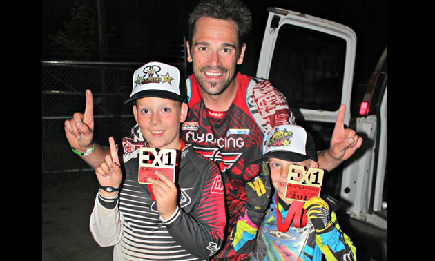 (L to R) Chase, Shane and Kale Cuthbertson each placed first in their class at an EX event in Sandpoint, Idaho, in early July. Shane said the event was fun for the boys because the kids raced on a separate track with smaller obstacles. <br /><strong>- Charla Cuthbertson photo</strong> Photo of a father with his two young sons and their are holding up their index fingers to signify the number one.