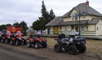 4 Quads in front of the old rail station at Smoky Lake.