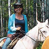 People riding horses and a man on a vehicle