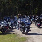 A group of motorcycles parked by a fire truck. 