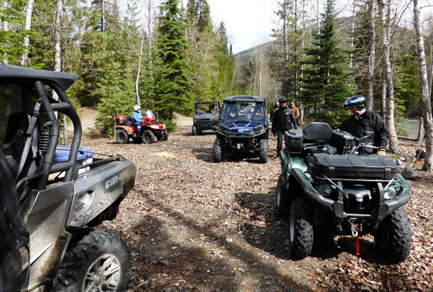 Several ATVs and UTVs parked by a river in Creston, B.C. 