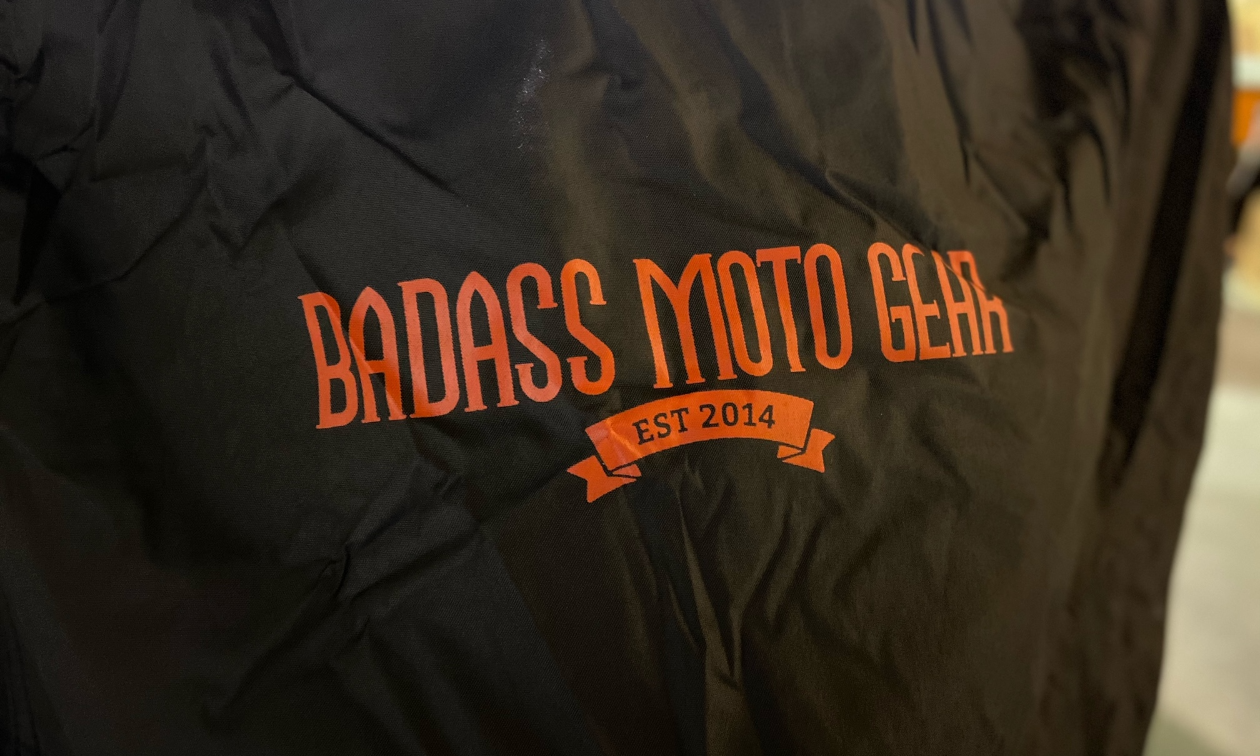 The Badass Moto Gear logo in orange on a black background.