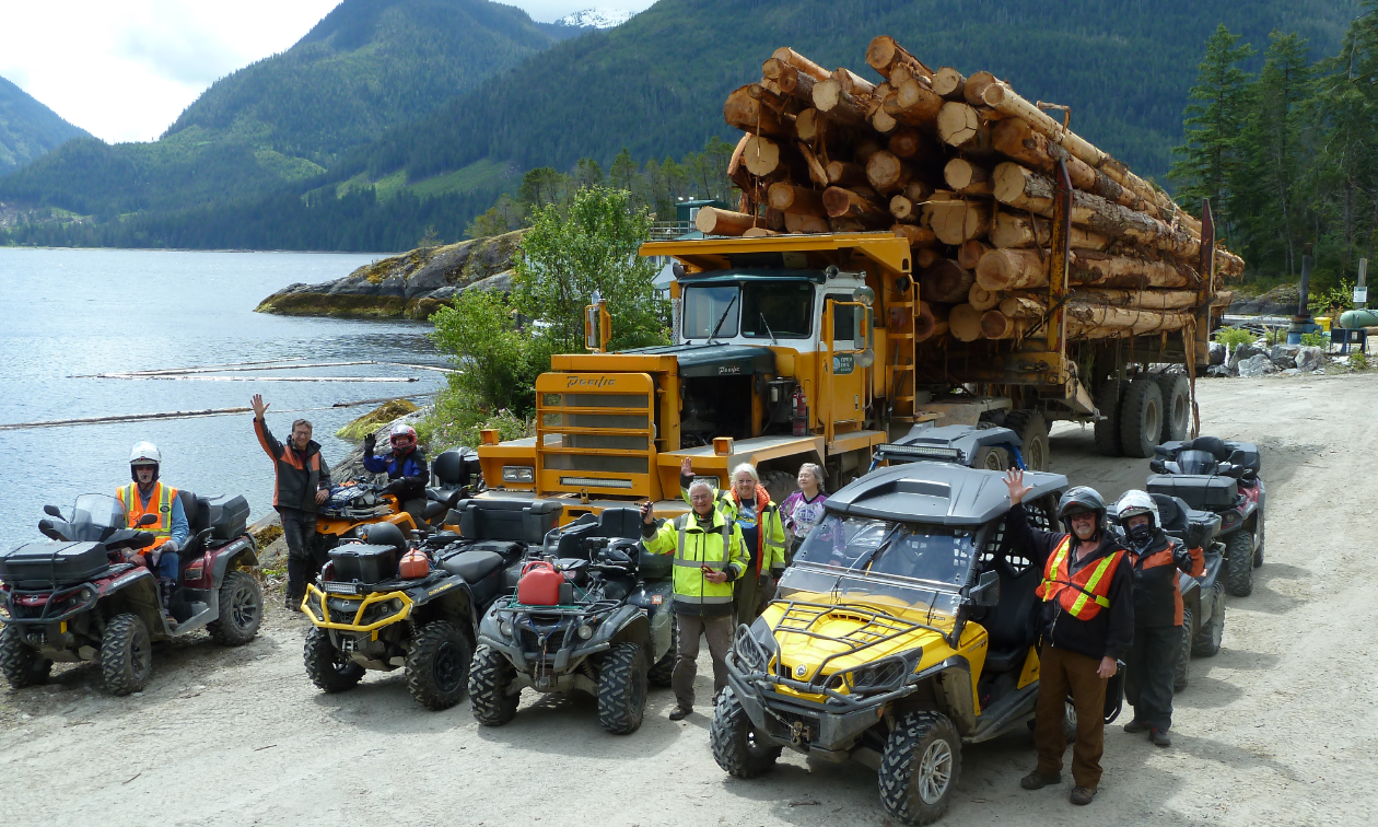 This off-road logging truck towers over quaders at McCurdy Creek log dump in Gold River, B.C.