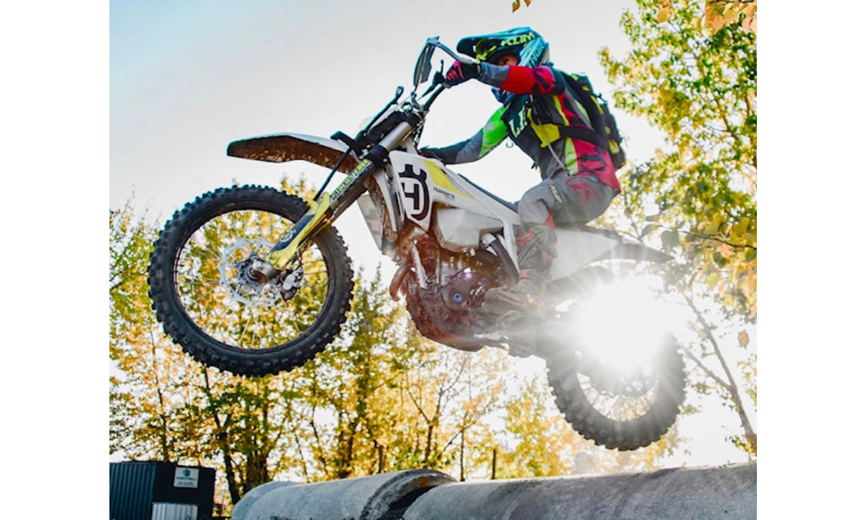 Jenny Hashimoto-Wiebe jumps over a pipe with her dirt bike. 