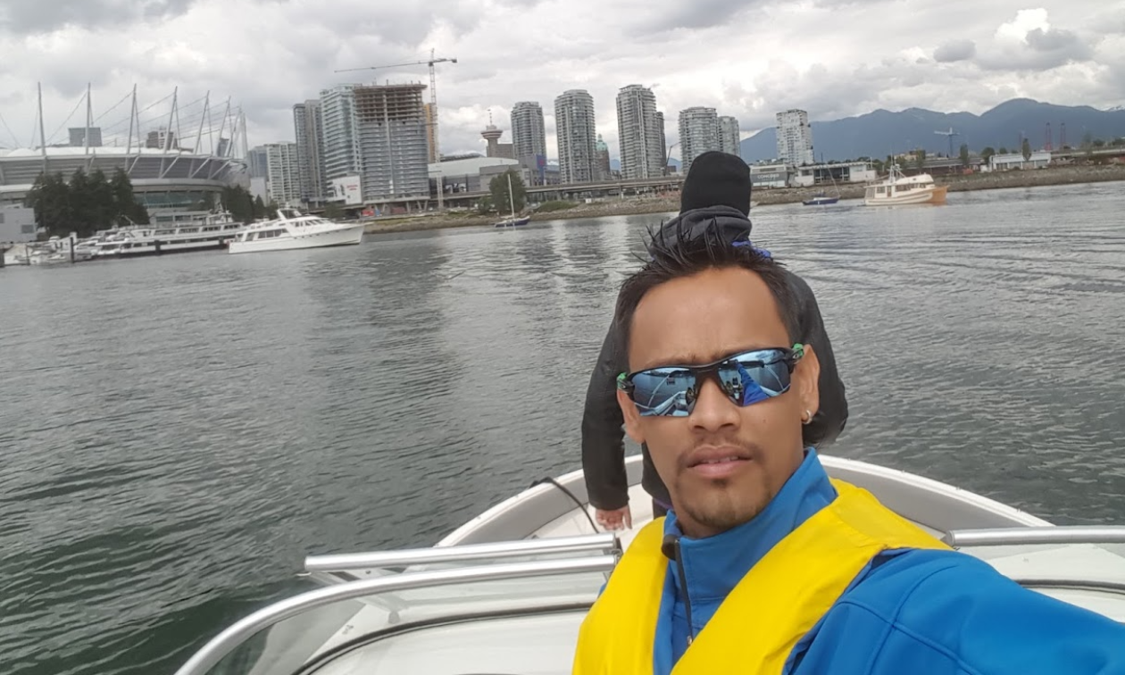 The Vancouver shoreline is behind Melvin Garib as he rides his 2015 Bayliner 190 OB Bowrider.