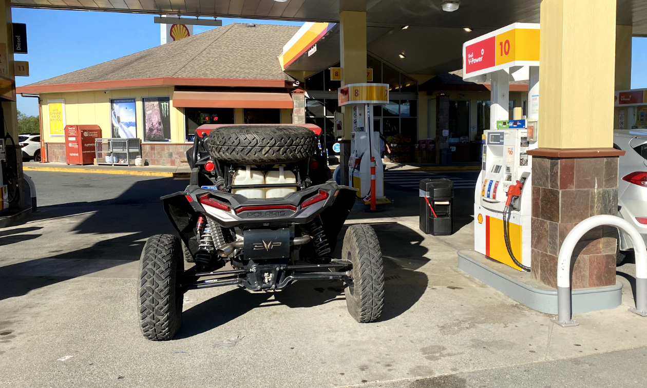 An ATV is parked next to a Shell gas pump on Vancouver Island. 
