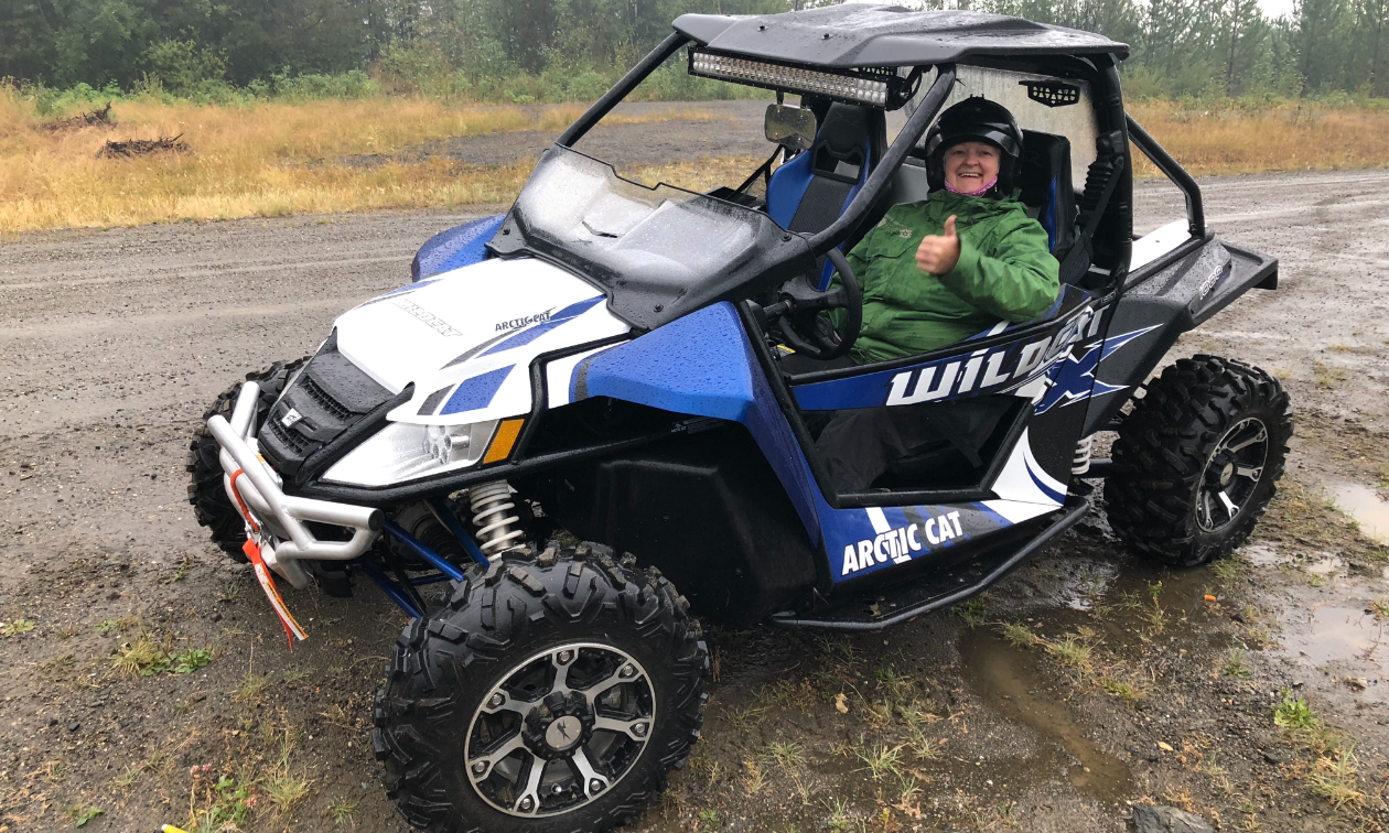 Nycole Ross rides a souped-up Arctic Cat Wildcat 1000 X, outfitted with a winch, hard roof, front and back extended fenders, LED light bar, extra brake light and rear backup lights, rock guards/sliders, bottom doors, upgraded steering system, front and back bumpers, front and back windows, rear storage cargo box, upgraded tires, and a Garmin GPS. 