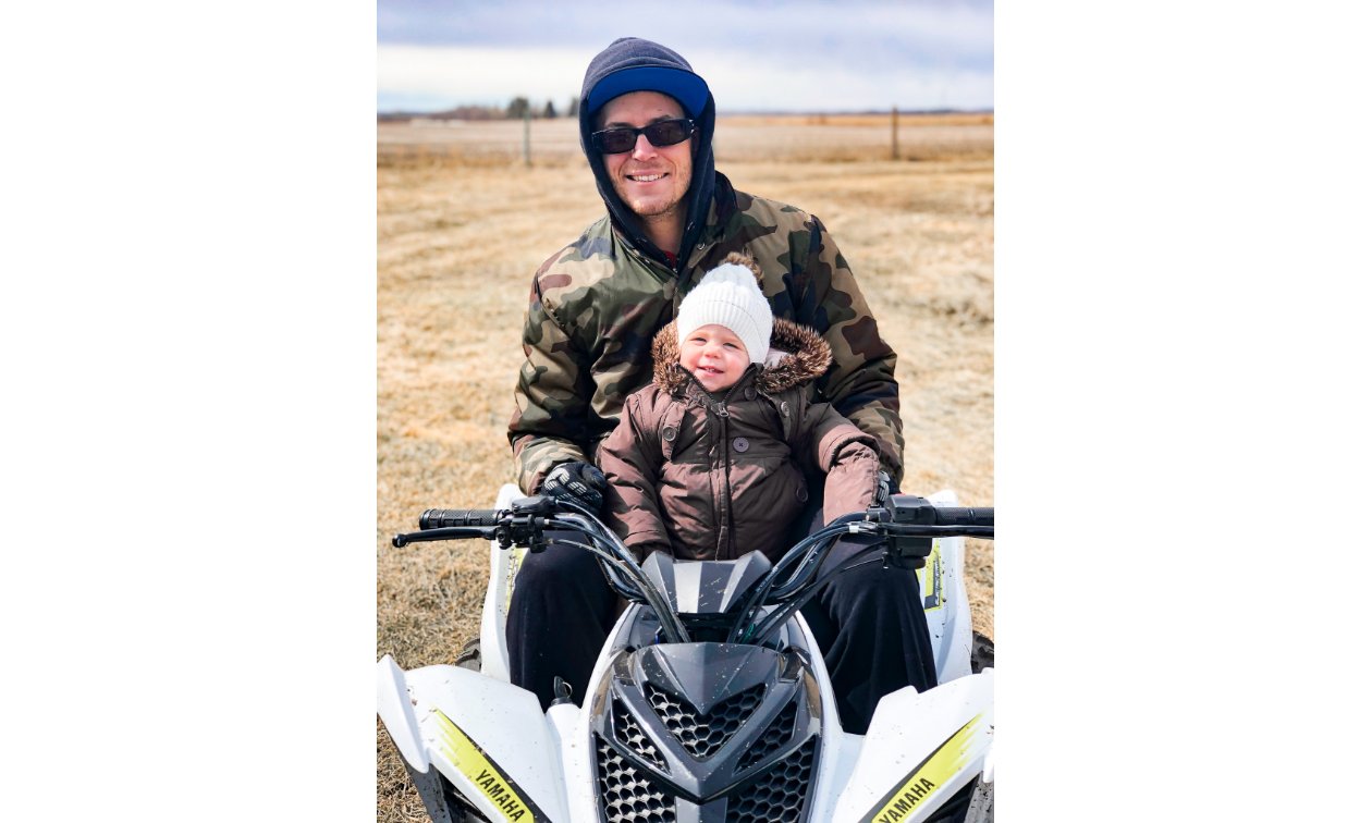 Dan Militere rides a Yamaha ATV with his small daughter, Tess. 
