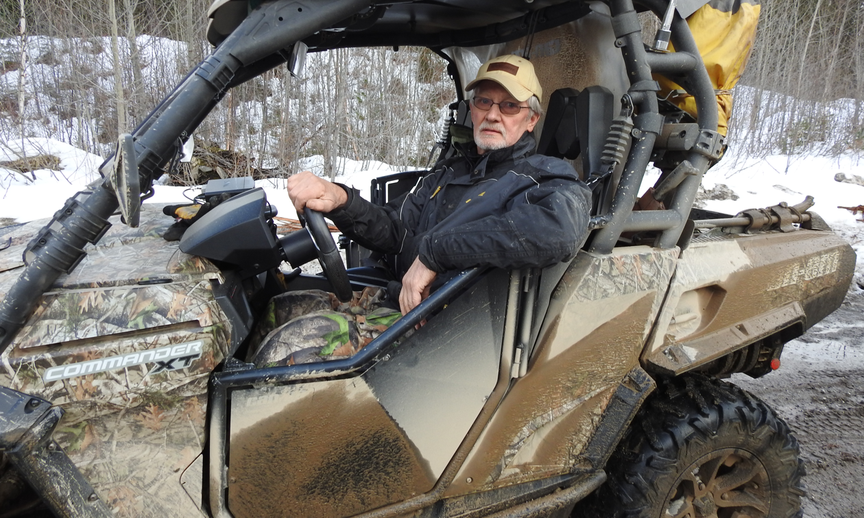 Ron Laroy relaxes inside his dirty Can-Am Commander 1000.