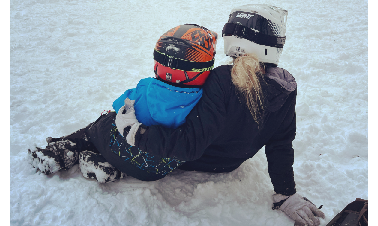 Sammi Lynn Clayton wraps her arm around her son, Davian, as they sit in the snow together.  
