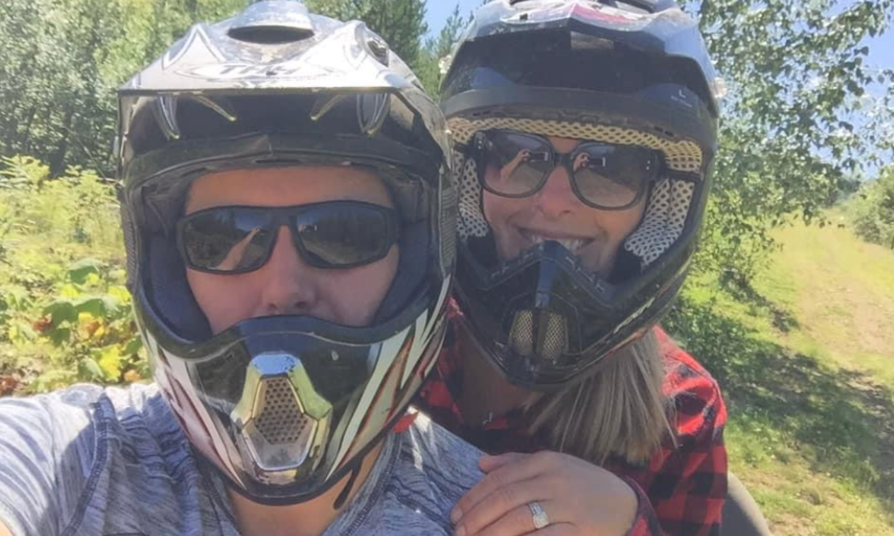 Sean Ellis and Melanie Berry wear sunglasses and ATV helmets. 