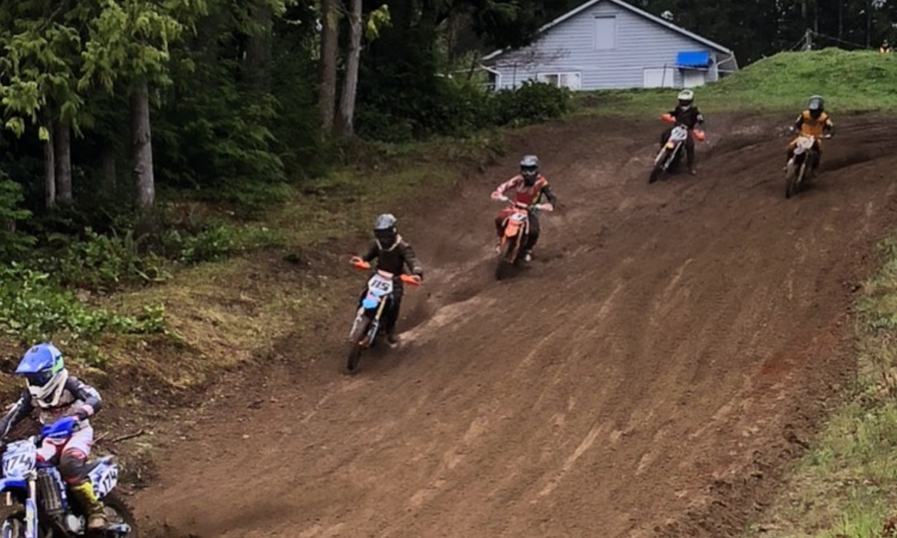 Dirt bike riders race down a hill at Westshore Motocross