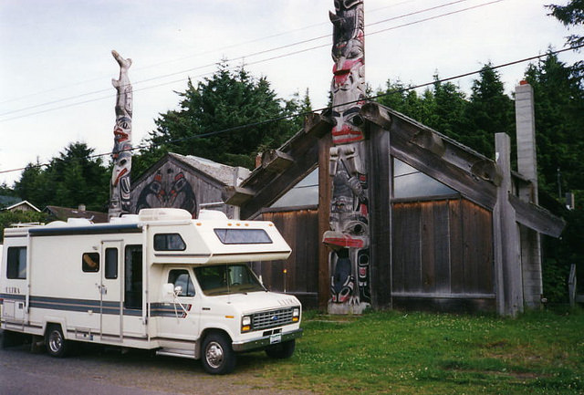 Phil Megyesi's motor home parked in front of Haida totem poles at Old Masset, B.C. 