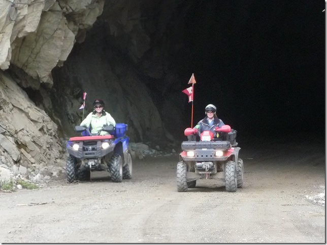 Delle Megyesi and Beryl Maxwell riding their quads out of a tunnel.