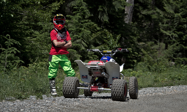 Christian Gagnon stands beside his ATV. 