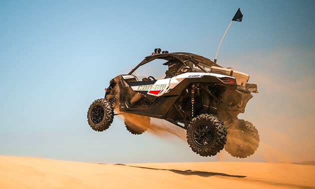 2018 Can-Am Maverick X3 R soaring over the dunes. 