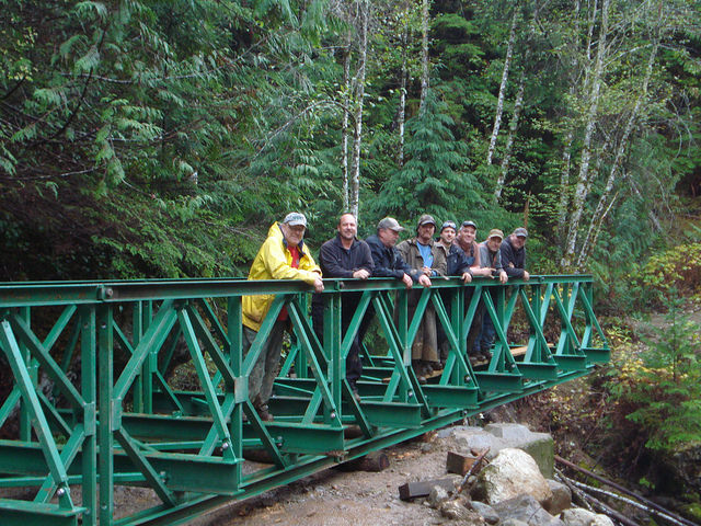 Eight members of the LMATV club standing on the Wallen Creek bridge.
