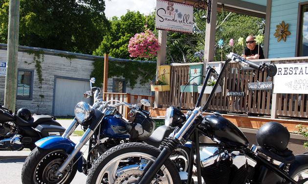 Motorcycles parked in front of Sanderella souvenir shop. 