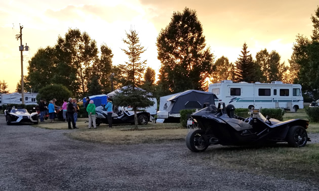 A Slingshot is parked in a campground.