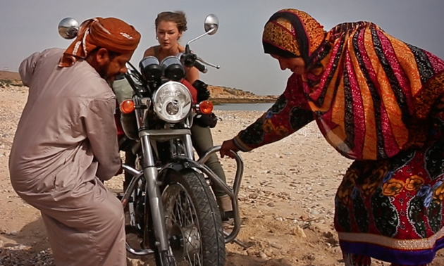 A nomadic couple helping Rosie Gabrielle get her bike unstuck. 