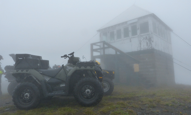 ATVs parked at Sproat Mountain Fire Lookout Tower in Revelstoke. 
