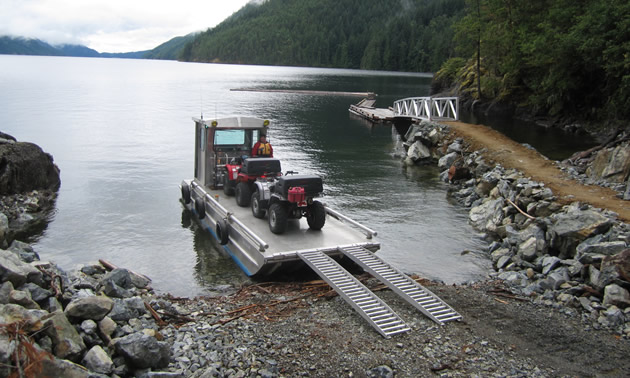 Offloading ATVs from a barge on Powell Lake. 