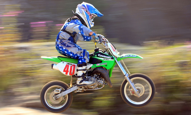 A 10 year old races on a dirt bike