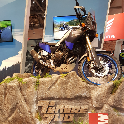 Blue, black and white 2021 Yamaha Tenere on a rocky platform. 