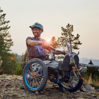 Christian Bagg sits on his Bowhead Reach trike at sunset.