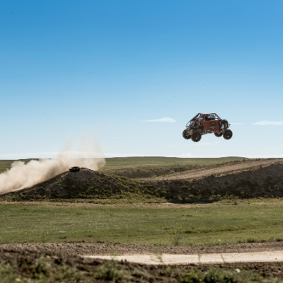 An ATV gets massive air off of a jump.