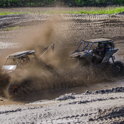 ATVs ride through the mud