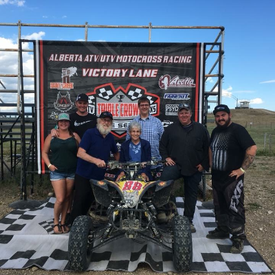 Jason Stapleton stands with friends with his ATV