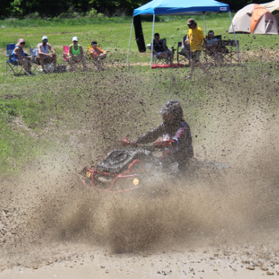 An ATVer rides through the mud