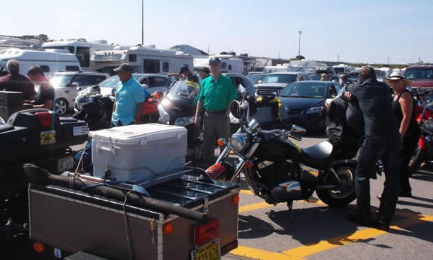 Motorcycles and cars on the ferry terminal. 