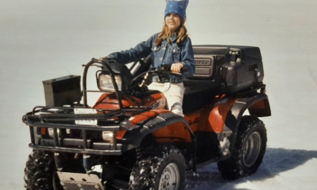 Ema as a child on a quad
