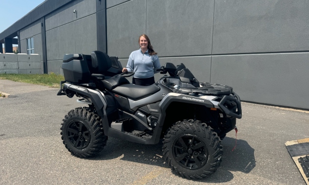 Ema standing behind her ATV