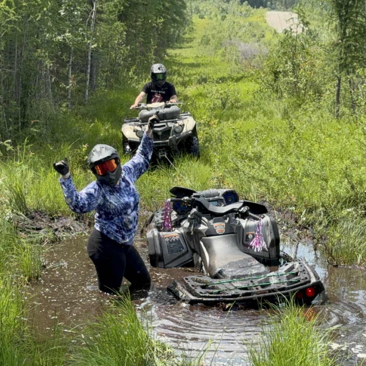 people riding ATVs through muddy terrain