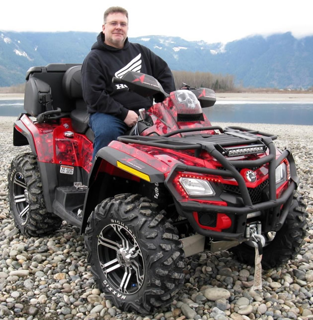An ATVer sitting on a quad.