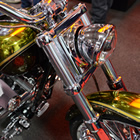 A close up of a shiny gold motorcycle.