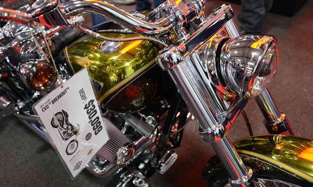 A close up of a shiny gold motorcycle.