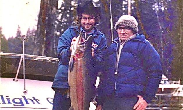 Lex and Fred Jones hold a large trout in an old photo.