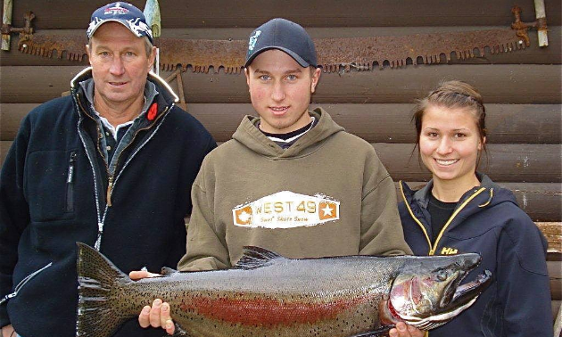 (L to R) Lex Jones, Chad Jones and Casey McKinnon are holding an 18-pound Gerrard rainbow trout.