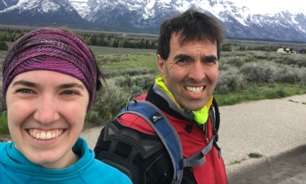 Marita Lindenbach and Graham Lindenbach smile in the foreground with mountains in the background.