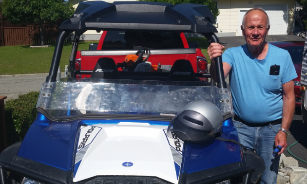 Dennis Saarela stands next to his 2014 Polaris RZR 800 in his driveway.