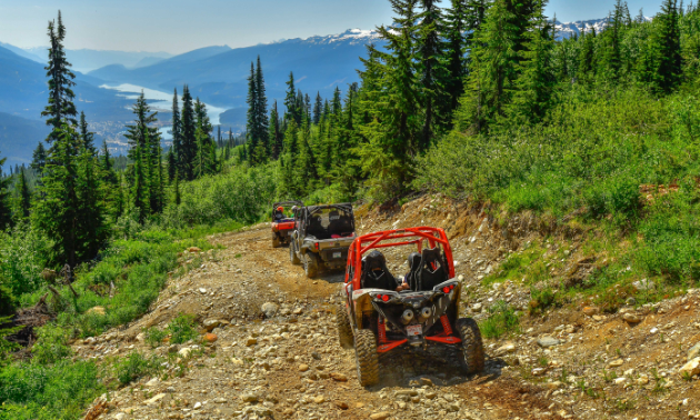 ATVs ascend a mountain road. 